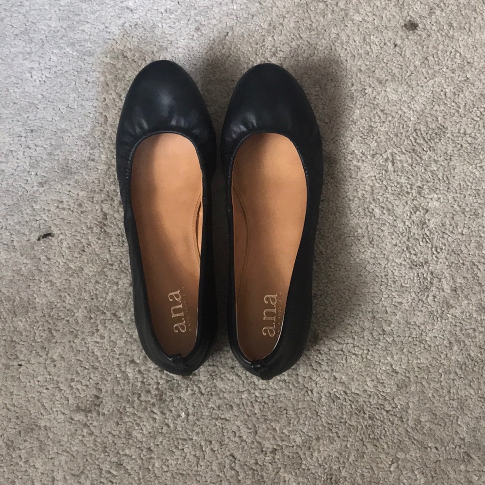 A pair of black flat dress shoes